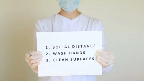 Doctor holds a paper with Coronavirus  basic protective measures Stock Footage 132605251