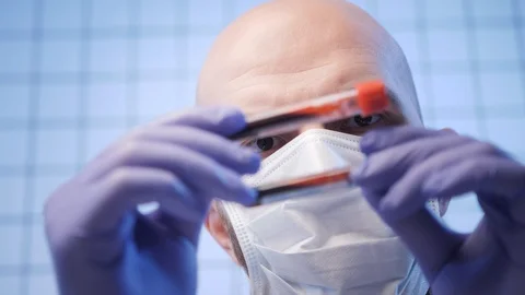 Doctor holds test tubes with sample of coronavirus closeup Stock Footage 126952384