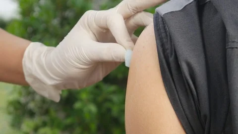 Doctor injecting flu vaccine to patient's arm Stock Footage
