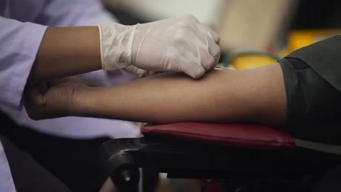 Doctor Inserting Needle into Arm for Blood Donation Stock Footage 345551109