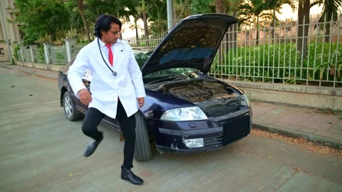 Doctor inspecting broken down car on roadside Stock Footage 278022809