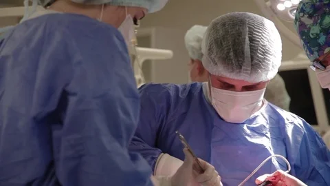 Doctor install a hip joint prosthesis Stock Footage 80140929
