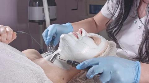 Doctor level the skin on the face Stock Footage 76457936
