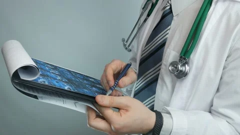 A doctor is looking at a chest x-ray Stock Footage 89830746