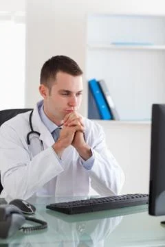 Doctor looking at computer screen Stock Photos