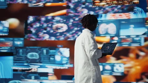 Doctor looking at genomes on notebook screen, comparing infection models Stock Footage 318626933