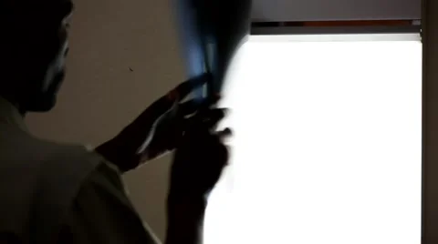 Doctor looking at X-ray in front of an illuminated panel Stock Footage 49011369