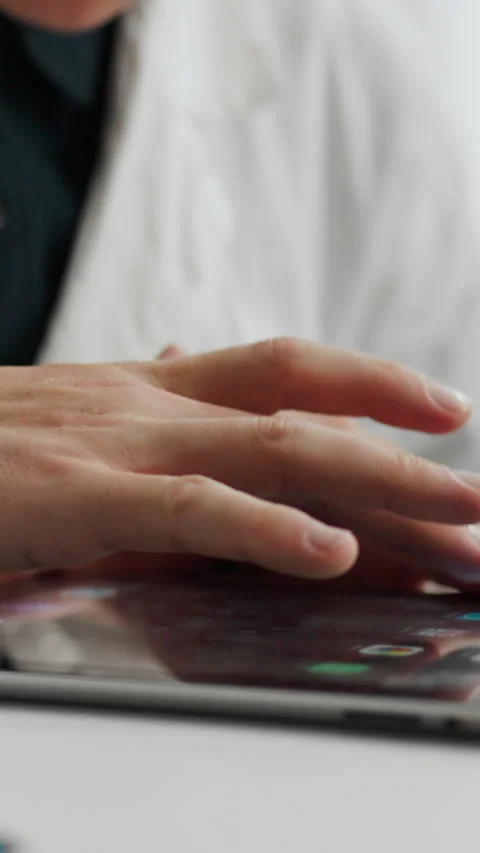 The doctor looks at the tablet screen using gestures he moves through applic Stock Footage 331729999