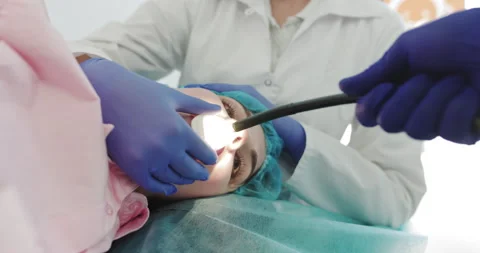 Doctor Makes An Endoscopy Through The Mouth Of A Young Girl, Pulls Out A Tube Stock Footage 148226474
