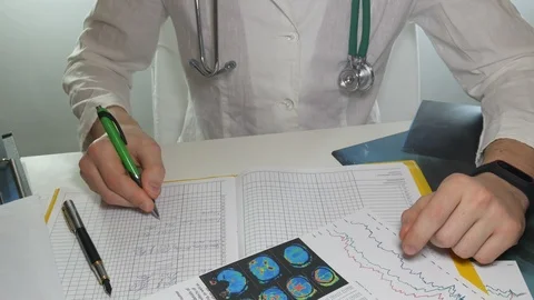 Doctor makes notes in the journal Stock Footage 86825290
