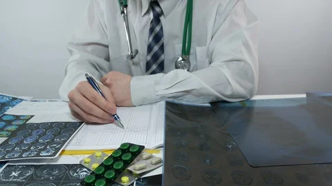 Doctor makes notes in the journal Stock Footage 87035593