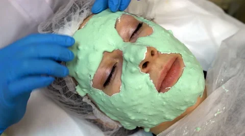 Doctor making off cosmetic mask on face Stock Footage 60819853