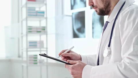 Doctor is making notes on the clipboard. side view. Stock Footage 157392801