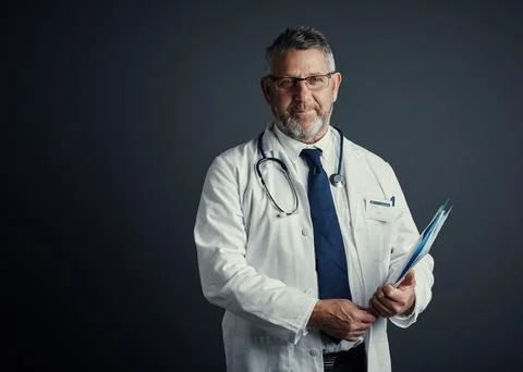 Doctor, man and folder in studio portrait with glasses, mockup space and pa.. Stock Photos