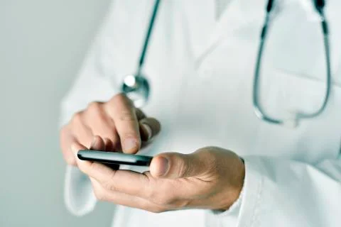Doctor man using a smartphone 写真素材
