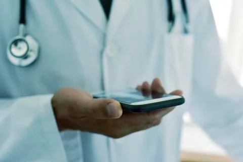 Doctor man using a smartphone Foto stock