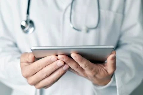 Doctor man using a tablet computer Stock Photos