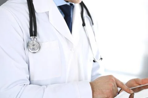 Doctor man using tablet computer for network research or virtual disease Фото