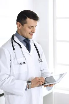 Doctor man using tablet computer for network research or virtual disease Stock Photos