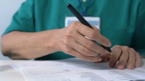 Doctor marking checkboxes in analysis list developing curing strategy laboratory Stock Footage 119298912
