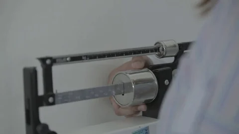 Doctor measuring the patient's weight Stock Footage