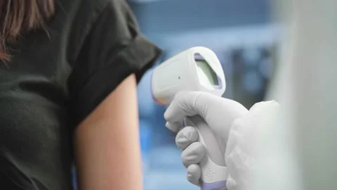 Doctor Measuring Temperature After Vaccinating From COVID Coronavirus Stock Footage 145498838