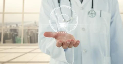 Doctor mid section with white interface and flare on hand against blurry window Stock Photos