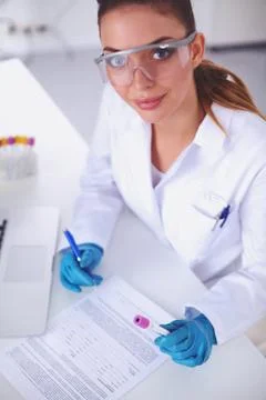 Doctor notes something after the experiment, isolated on white Stock Photos