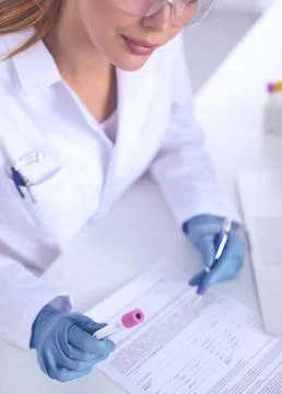Doctor notes something after the experiment, isolated on white Stock Photos