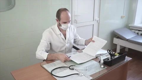 The doctor in the office records the appointment Stock Footage 130931521