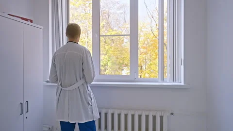 The doctor in the office is standing by the window, looking forward Stock Footage 255801952