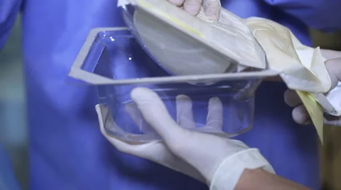 The doctor opens the breast implants Video stock 61110226