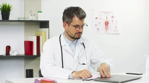 Doctor opens the pc and start working on it Video stock 135911051