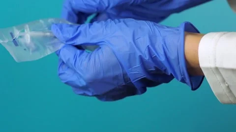 Doctor opens sterile syringe packaging for medical injection. Stock Footage 148496715