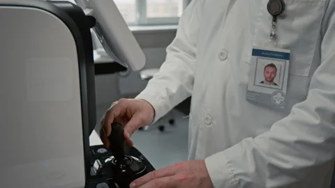 Doctor Operating Controls on Ophthalmic Diagnostic Device Stock Footage 322664575