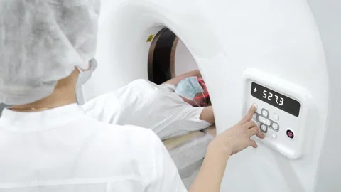 Doctor operating CT scanner during patient diagnostic procedure. 스톡 동영상 347776914