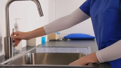 Doctor or nurse washing hands with liquid soap Stock Footage
