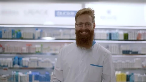 A doctor or pharmacist is looking at the camera and smiling. Portrait Stock Footage 124989037