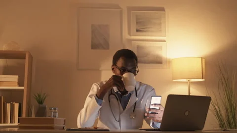 Doctor overwork night shift laptop phone coffee Stock Footage 201746542
