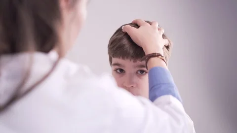 Doctor is palpating lymph node on the neck of 7 years old boy, medical checkup Stock-Footage 101704172
