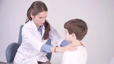 Doctor is palpating lymph node on the neck of 7 years old boy, medical checkup Stock-Footage 101704235