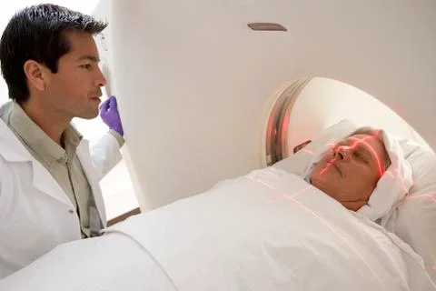 Doctor With Patient Having A Computerized Axial Tomography (CAT) Scan Stock Photos