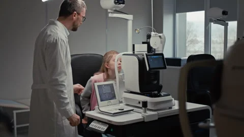 Doctor Performing Eye Test For Girl Stock Footage 322677753
