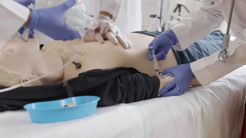 Doctor performing first aid and injection on dummy in medical clinic Stock Footage 270176449