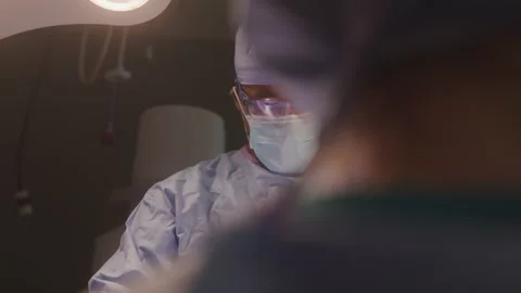 Doctor Performing Surgery Stock Footage 211880878