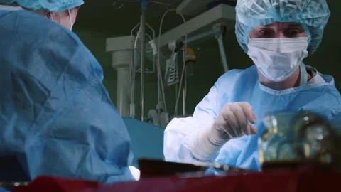 Doctor Performing Surgery Using Sterilized Equipment. Surgical Team Performing Video stock 254351448