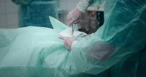 The doctor performs a pediatric surgical operation to remove the tonsils Stock Footage 163959424