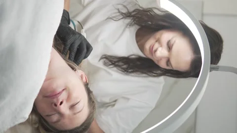 The doctor performs a procedure to increase the growth of hair on the clients Stock Footage 310722787