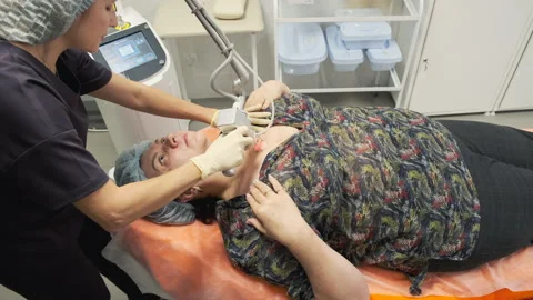 The doctor performs the procedure of lifting with a laser Stock Footage 144992207