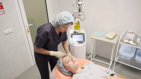 The doctor performs the procedure of lifting with a laser Stock Footage 144996754